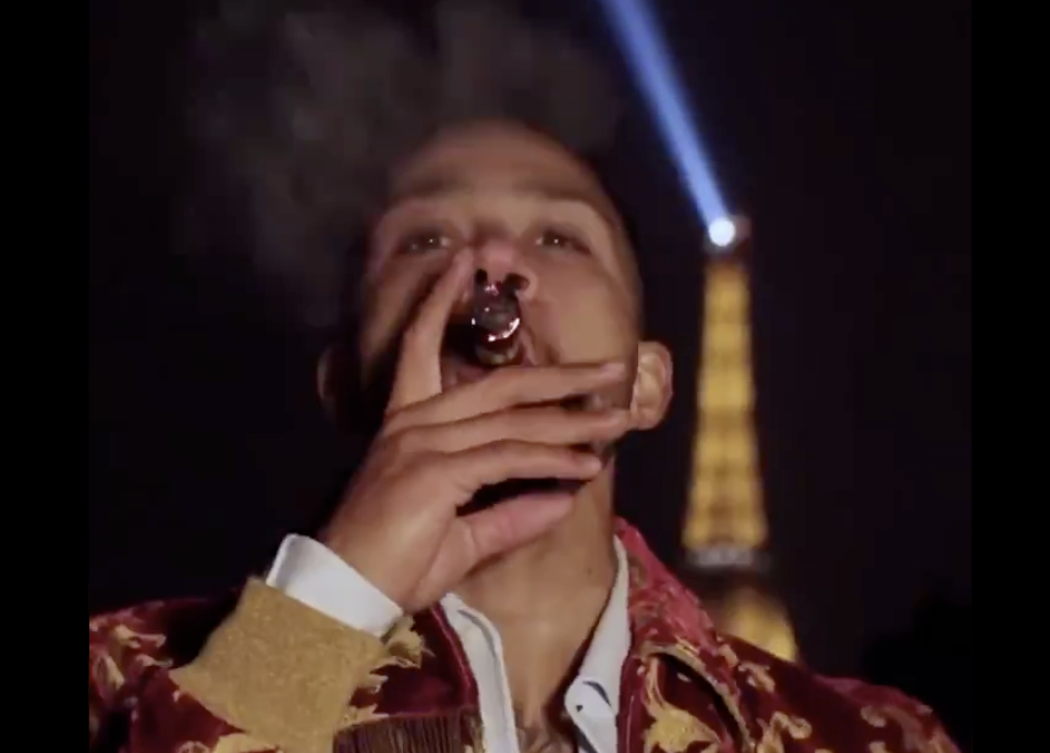 Memphis Depay puffs on a cigar as he strolls alongside Italian