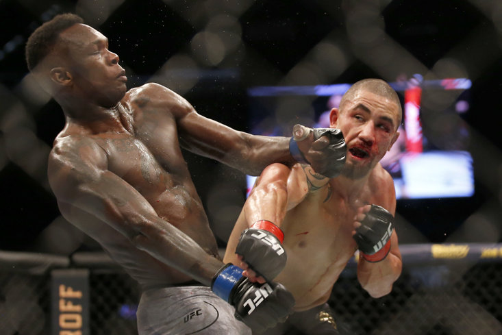 Robert Whittaker (right) in his defeat to Israel Adesanya